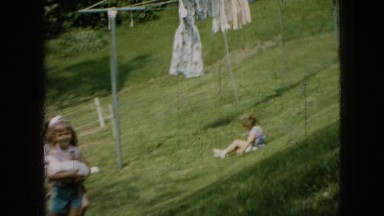 1965: children playing together on hill outside while mothers watch WELLSBURG