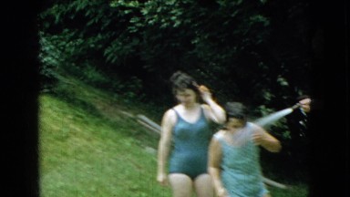 1965: family having fun with a water hose on a hot summer day. WELLSBURG IOWA