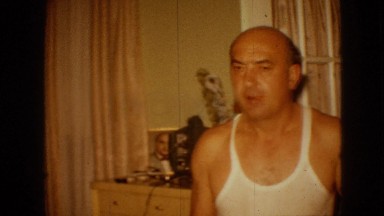 1967: an old angry bald white man shouting at someone at his house in his room