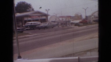 1968: car driving by an amusement park and stopping at a stop light MISSOURI