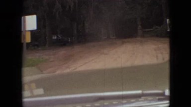 1968: A Car Driving Down a Dirt Road as Seen Through the Windshield MISSOURI