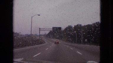 1968: car moving high speed highway signboard street lamps trees around MISSOURI