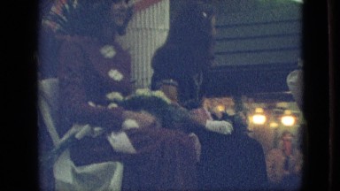 1968: three well-dressed girls sitting backwards and waving on parade float