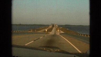 1968: car moving fast on highway water beside MISSOURI