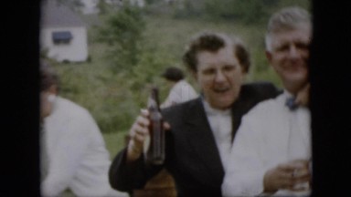 1957: A Group of People Laughing and Drinking Beer as a Lady Drops Her Bottle
