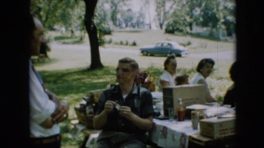 1957: a family outside, seated around a picnic table in a park PENNSYLVANIA