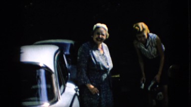1957: family standing near car and talking with visiting relative PENNSYLVANIA