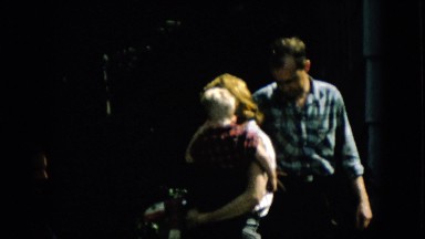 1957: an elderly woman talking with a man and a woman with a children