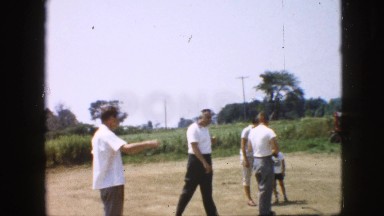 1957: man children men baseball lot trees sunshine foliage walking highway car