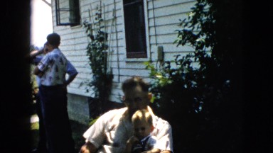 1957: father child sitting on lap shade residential love PENNSYLVANIA
