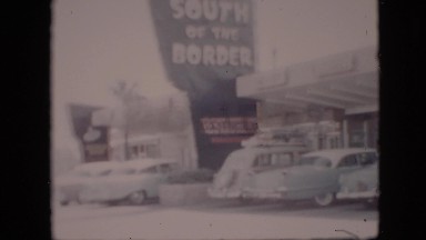 1958: number of cars are remaining parked before a beautiful building