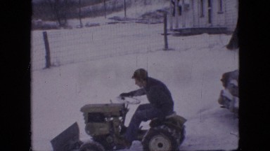 1964: through a snowy land a man drives a special truck and another man follows