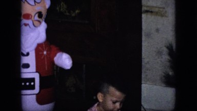1964: baby is playing with a santa claus toy PHILADELPHIA PENNSYLVANIA