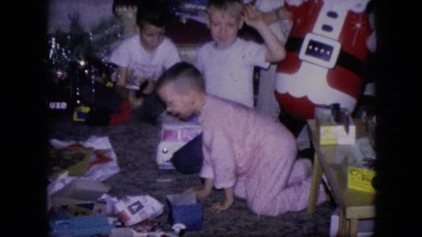 1964: children opening gifts together on christmas day, excited and jumping