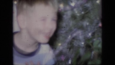 1964: little children laughing smiling playing anticipation near christmas tree