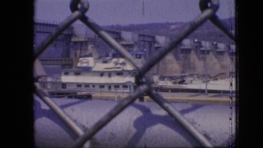 1964: peeking through a sturdy fence and seeing a boat on the other side.