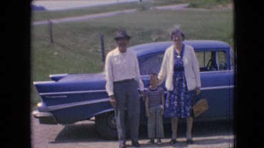1964: mom, dad, and son, in front of their blue car PHILADELPHIA PENNSYLVANIA