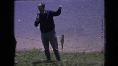 1964: father and son finishing with father holding up his catch PHILADELPHIA