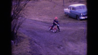 1964: child son boy bicycle wheel learning teaching dog scared running