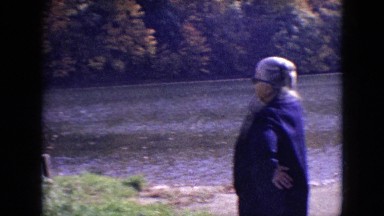 1964: woman standing out in the open, watching the lake go by. PHILADELPHIA