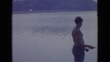 1965: men and boys fishing on a rocky shoreline with rods and bait