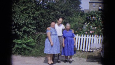1965: three people embracing posing happily in front of the camera