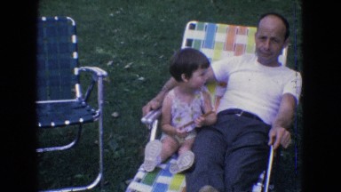 1965: father and child lounging on outdoor furniture. NEW JERSEY