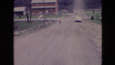 1966: An Older Man Riding a Moped and Smoking a Cigarette in Athens, Ohio