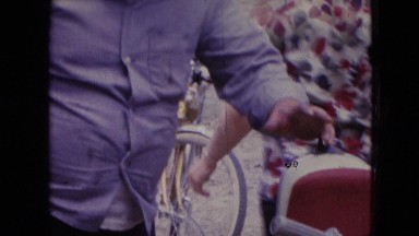 1966: one man in purple shirt and lady in red-black top doing something