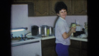 1966: woman preparing a baby bottle over the sink. ATHENS OHIO