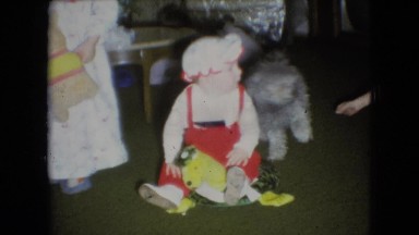 1966: cute child playing indoor near pet dog cuddling ATHENS OHIO
