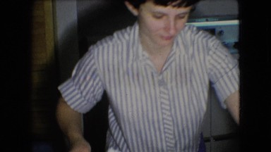 1966: mother serving dessert to her children while they sit at the table ATHENS