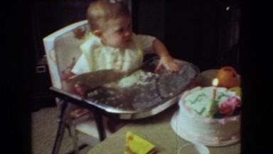 1966: baby sits at a table with a cake and chews on a plate ATHENS OHIO