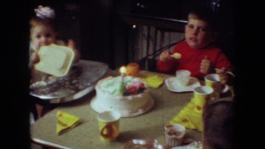1966: men and women childrens are sitting together to eating and drinking