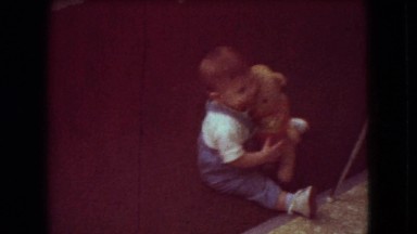 1966: an awesome kid sitting on the floor with a cute doll ATHENS OHIO