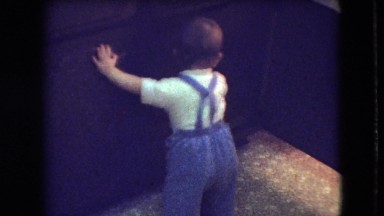 1966: curious kid looking through book holders