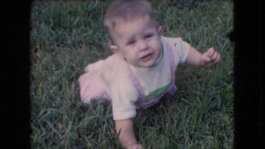 1966: cute baby crawling grass looking back talking enjoying ATHENS OHIO
