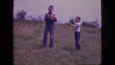 1966: two young boys outside in a neighborhood field flying a kite NEW JERSEY
