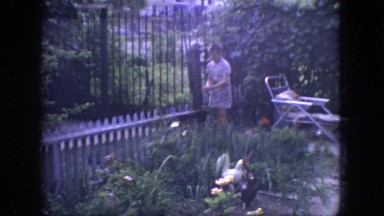 1966: little boy enjoying a pretty flower garden. NEW JERSEY