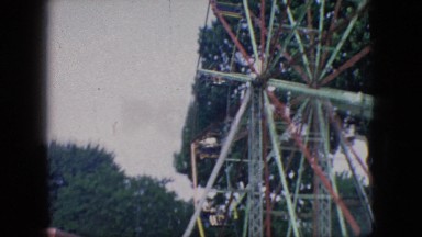 1966: crowded park on fair day at the amusement park enjoying ferris wheel