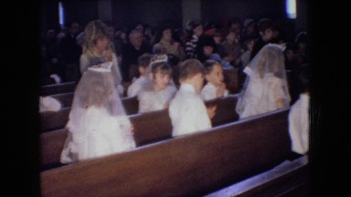 1966: little girls and boys all dressed in white in church for first communion