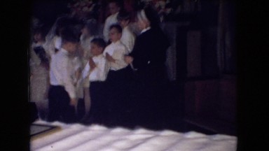 1966: a group of young children gather in a church to sing OHIO