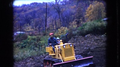 1966: country man drives bulldozer in empty dirt field OHIO