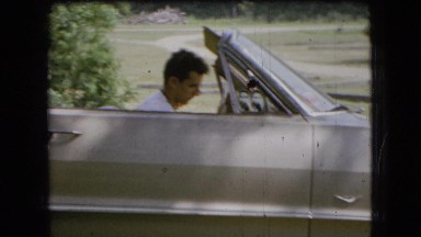 1966: a handsome young man sitting in a convertible with the top down OHIO