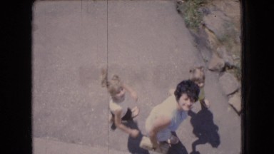1966: a woman with two small girl children walking down a stony steps OHIO