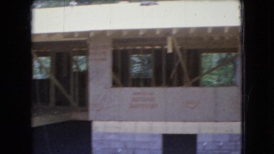 1966: a large building under construction in an area with many dwellings OHIO