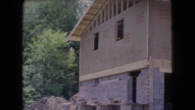 1966: a cinderblock foundation and wood beams support a house under construction