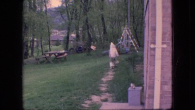 1966: child running thru garden toward swings OHIO