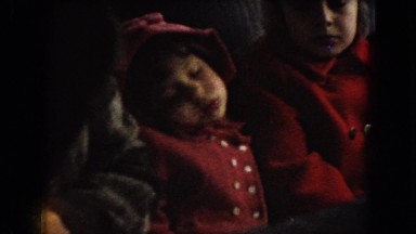 1966: four children sitting in the back seat of a car, one of them is sleeping.