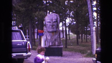 1974: a child walks by carved statue of face SOUTH DAKOTA